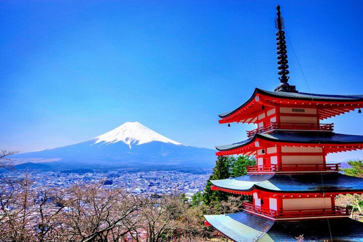 a red pagoda with a mountain in the background