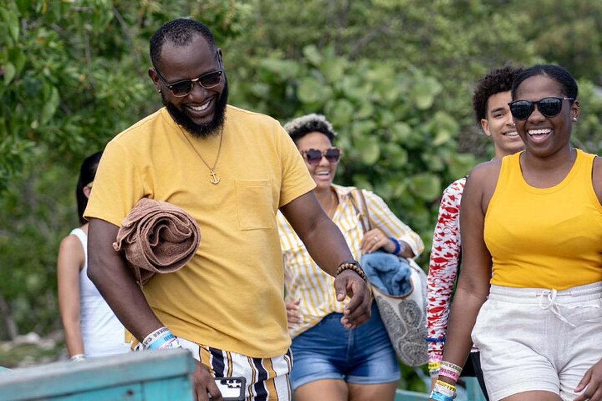 a man in a yellow shirt and a group of people