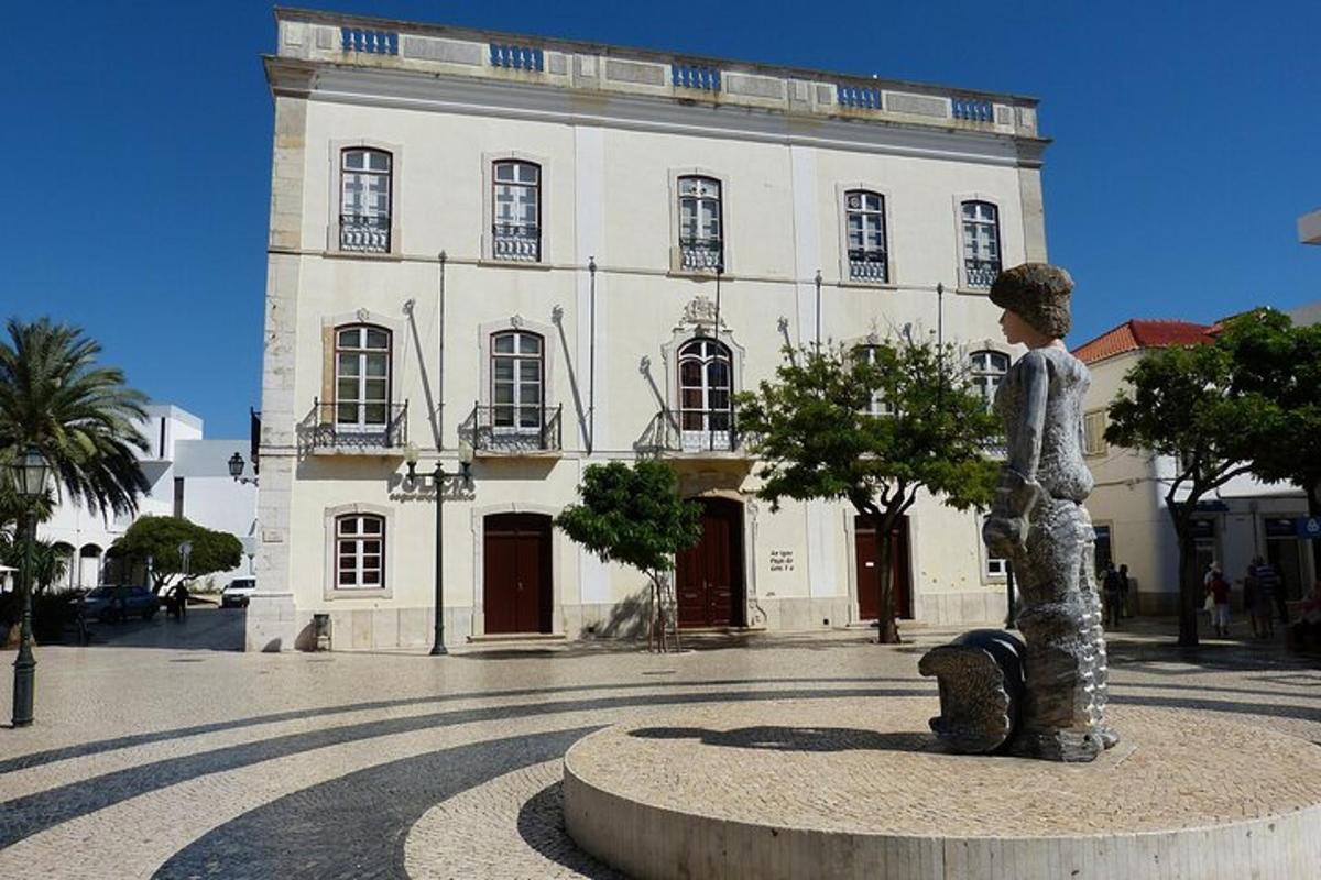 a statue of a boy in front of a building
