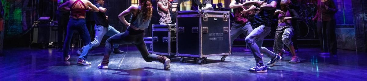 a group of people dancing on a stage
