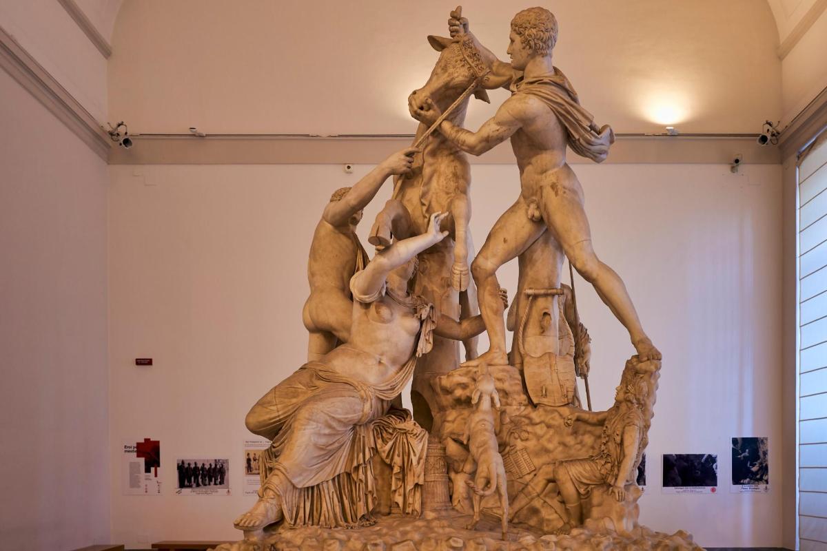 a statue of a group of men in a fountain