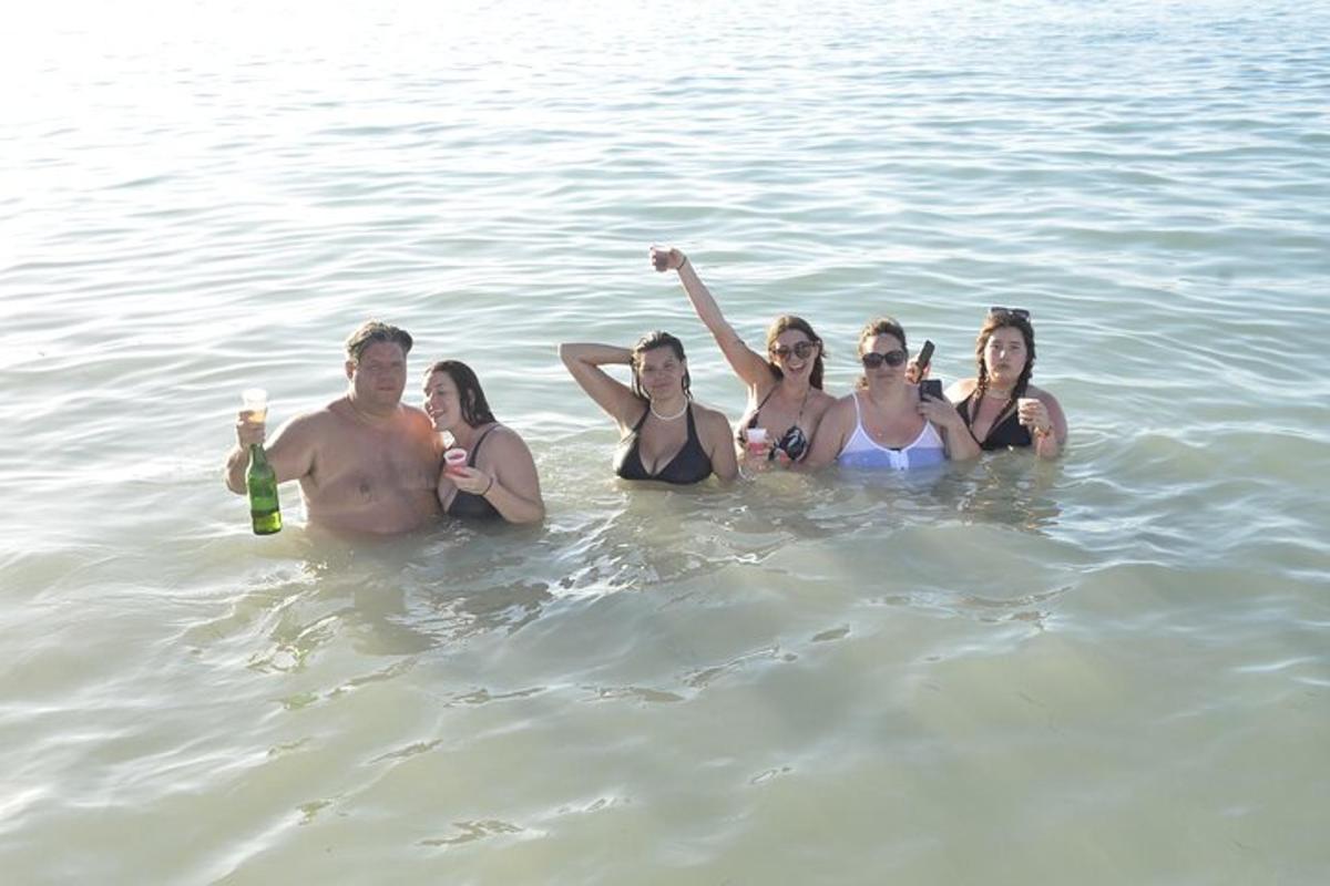 a group of people are standing in the water