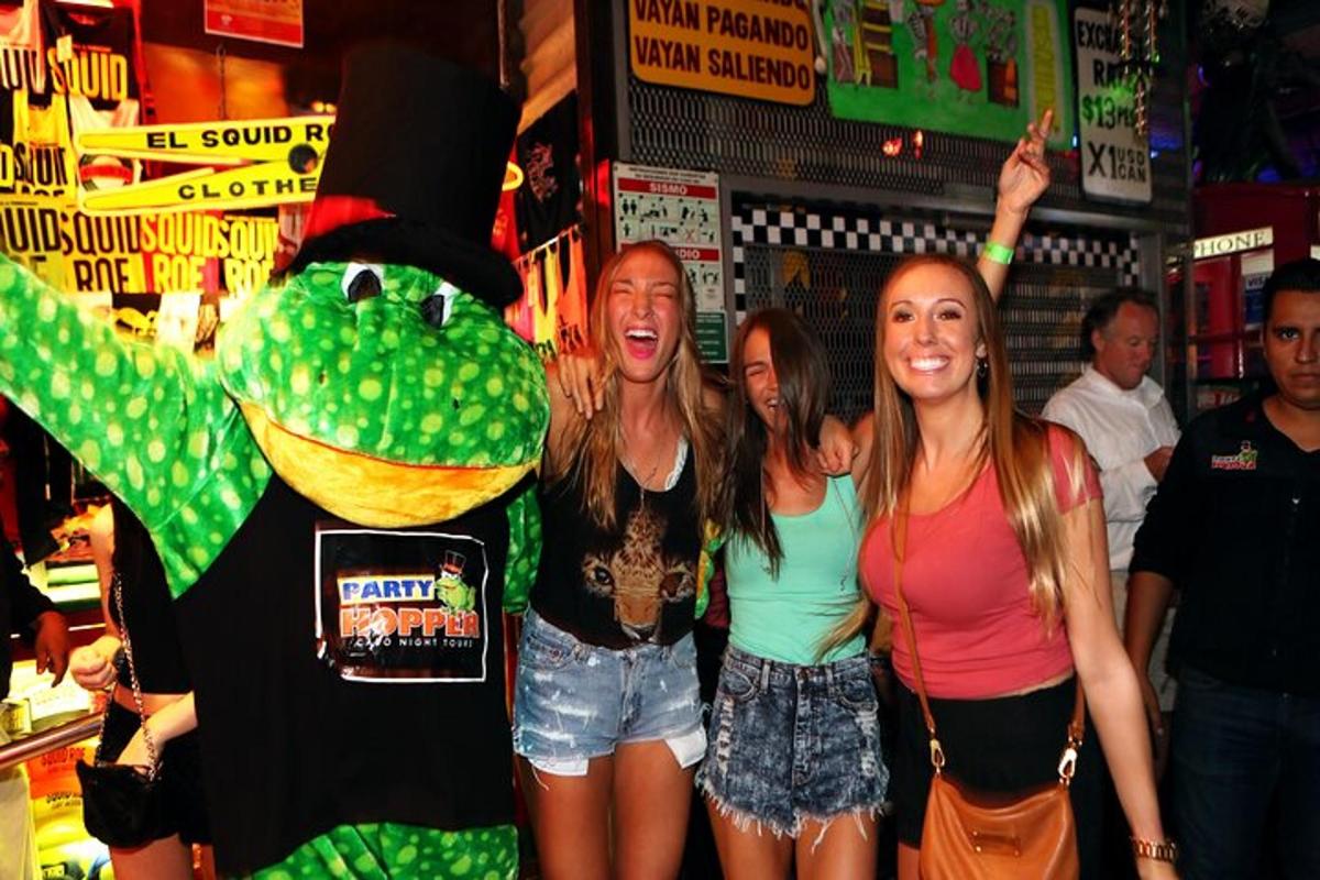 a group of girls standing next to a person dressed in aesame street costume