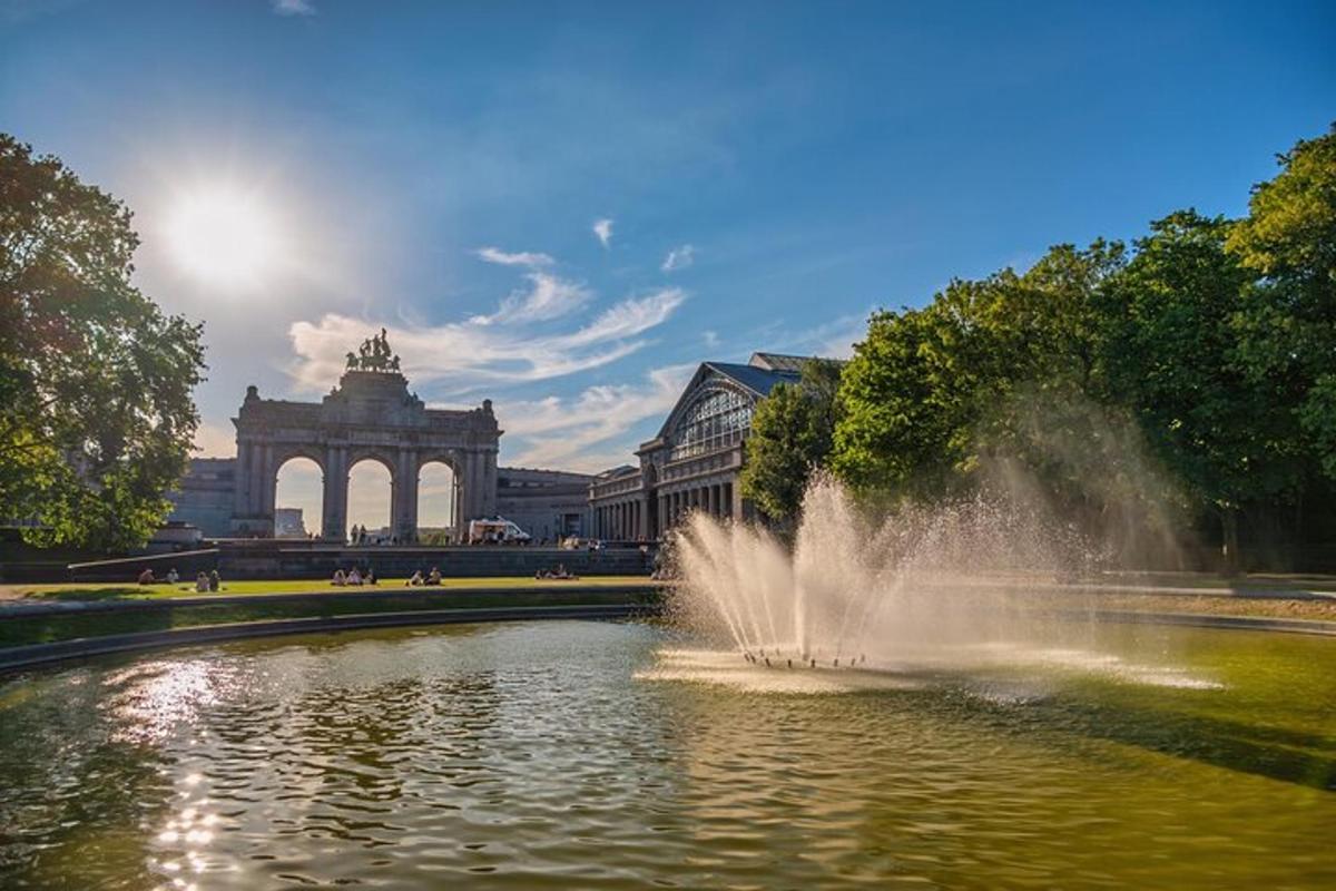 a fountain in a pond in front of a building