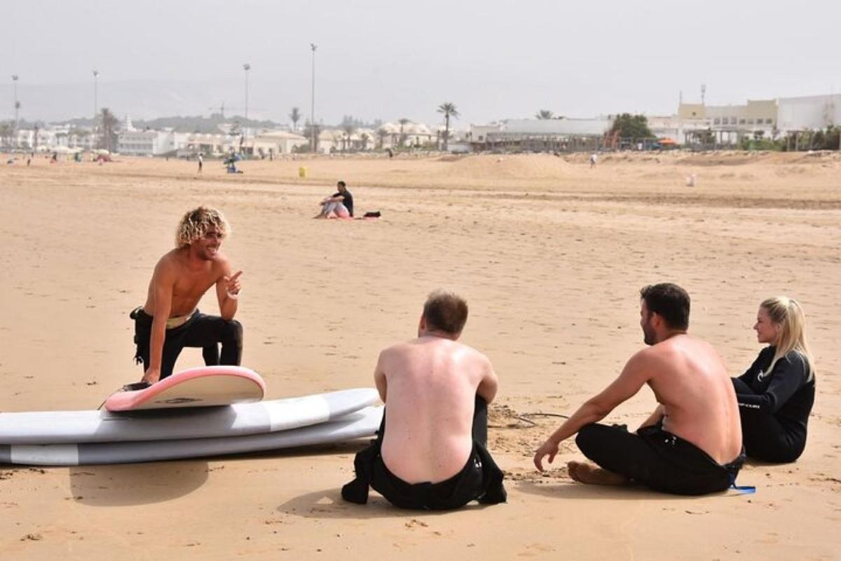 a group of people sitting on the beach