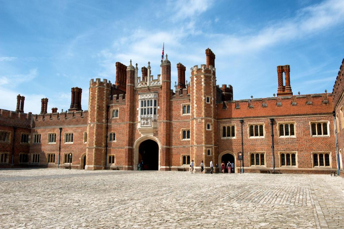 a large brick building with a courtyard in front