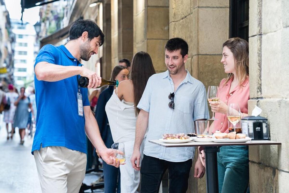 a man is pouring wine into a plate of food