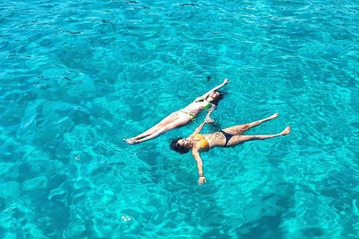 two women laying in the water in the ocean
