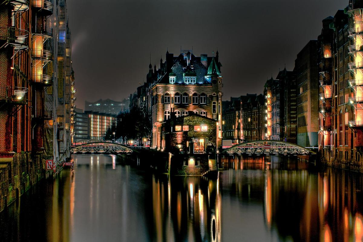 a city at night with a river and buildings