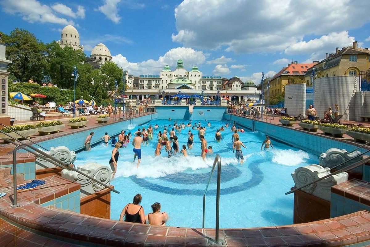 a group of people in a swimming pool at a resort