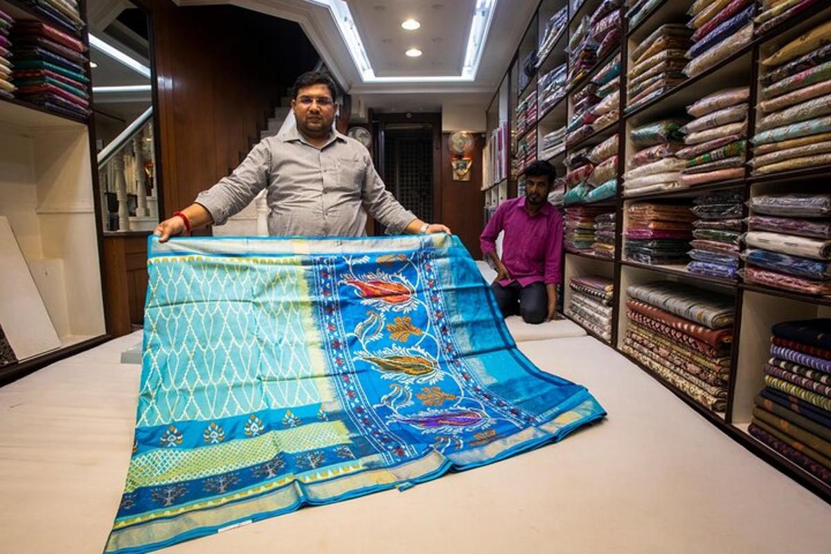 a man standing in a store holding a blanket