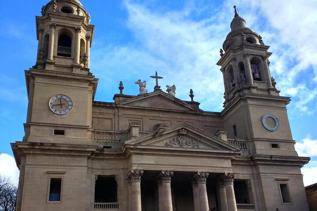 a large building with a clock tower and a cross
