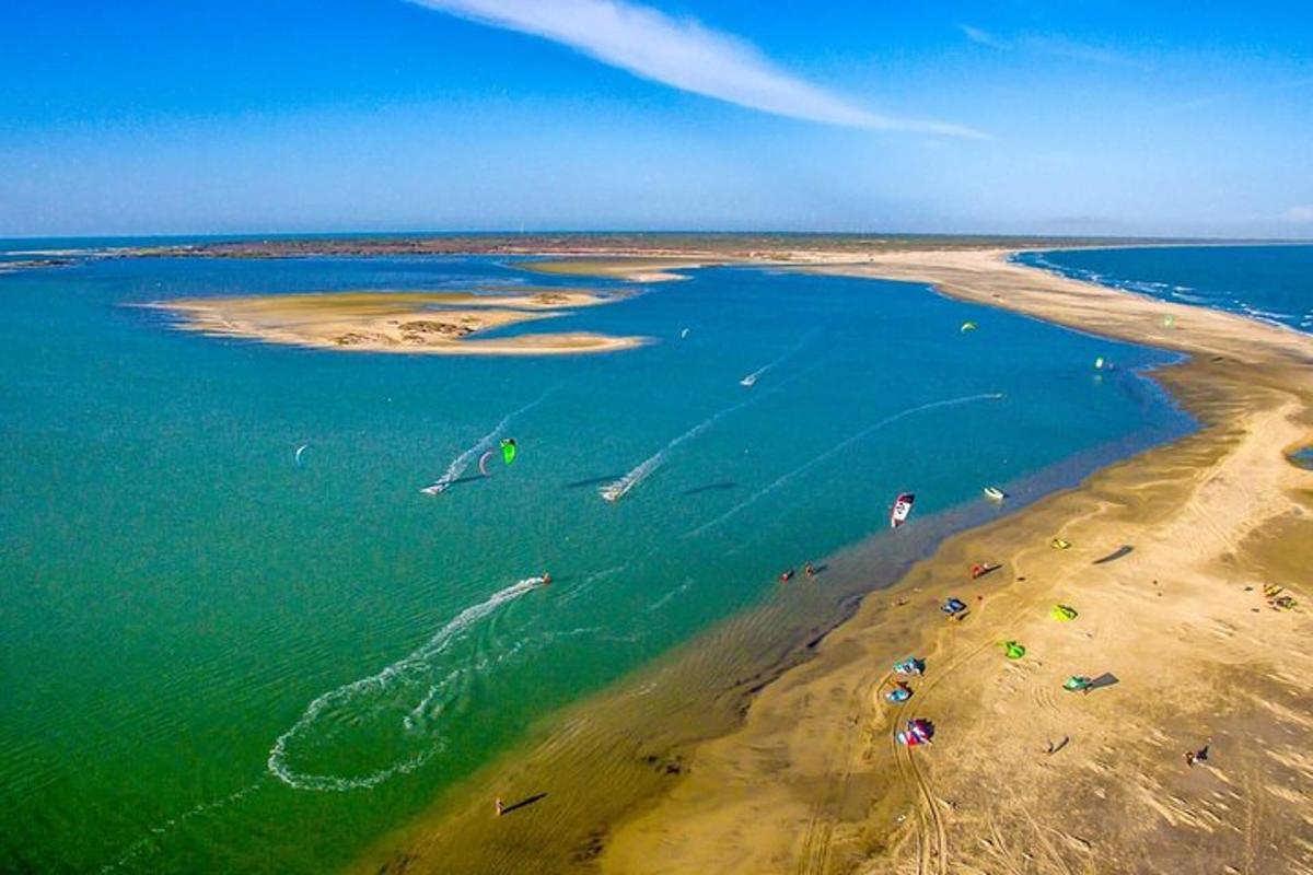 een luchtfoto van een strand met mensen in het water