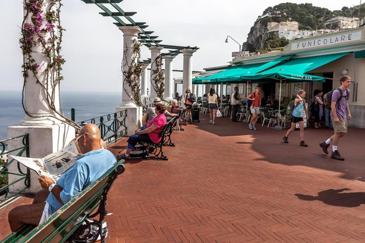 a man sitting on a bench next to the ocean