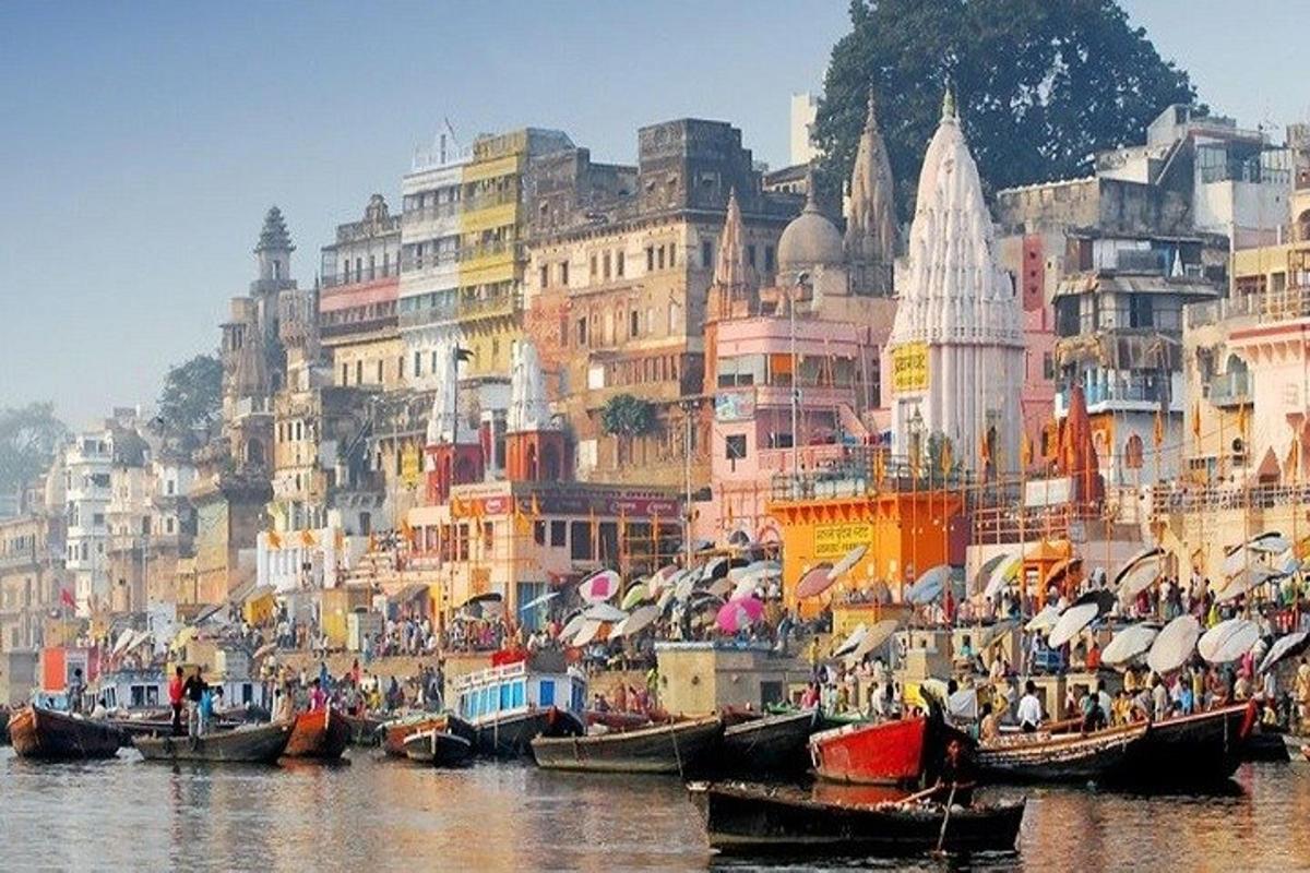 a group of boats in a body of water with buildings