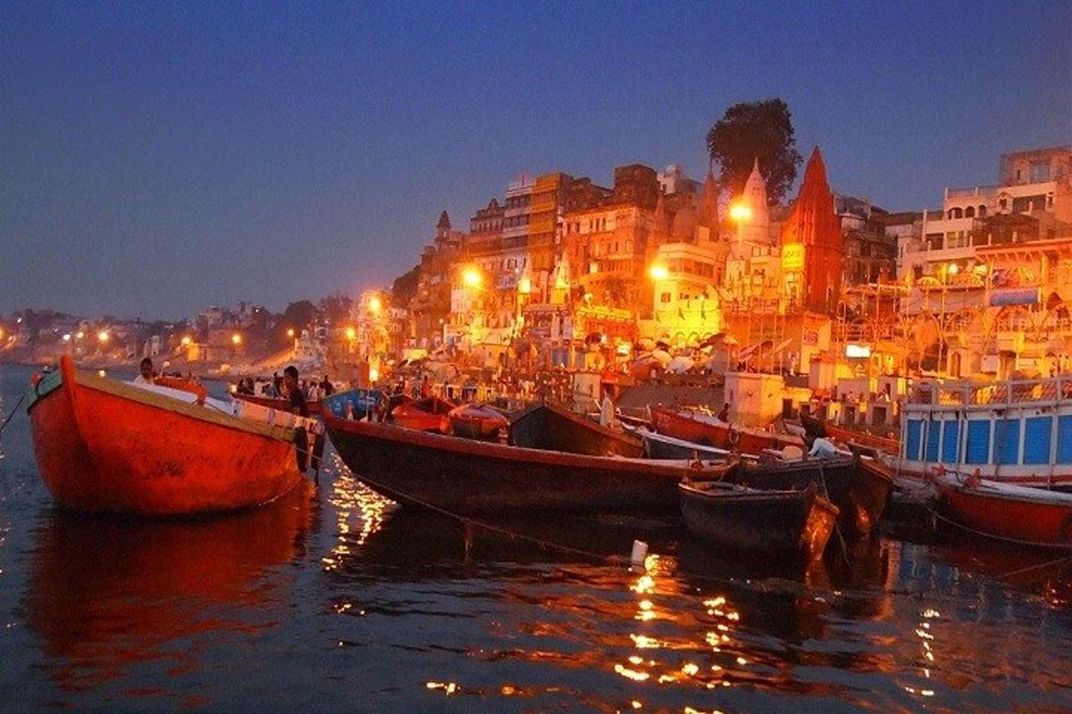 a group of boats sitting in the water at night