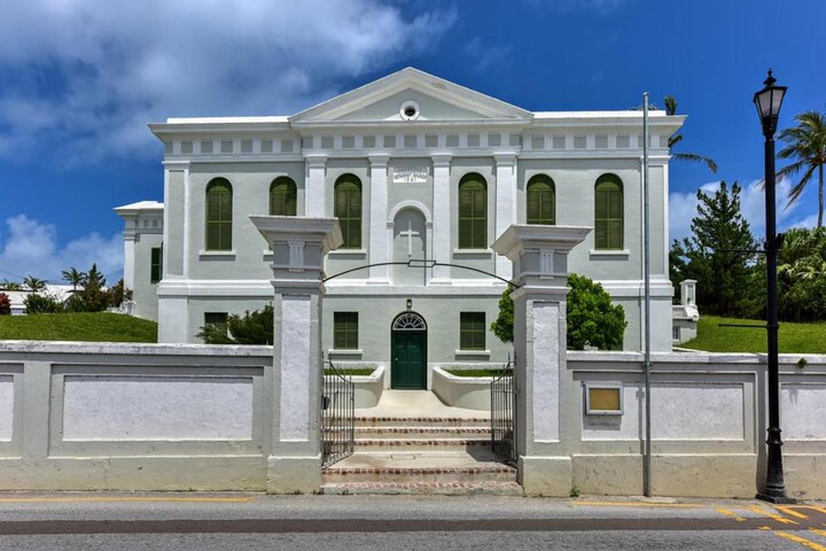 a white house with a gate in front of it