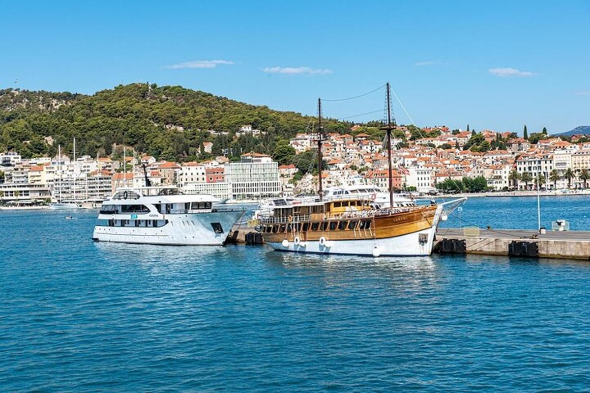 three boats are docked in the water near a city
