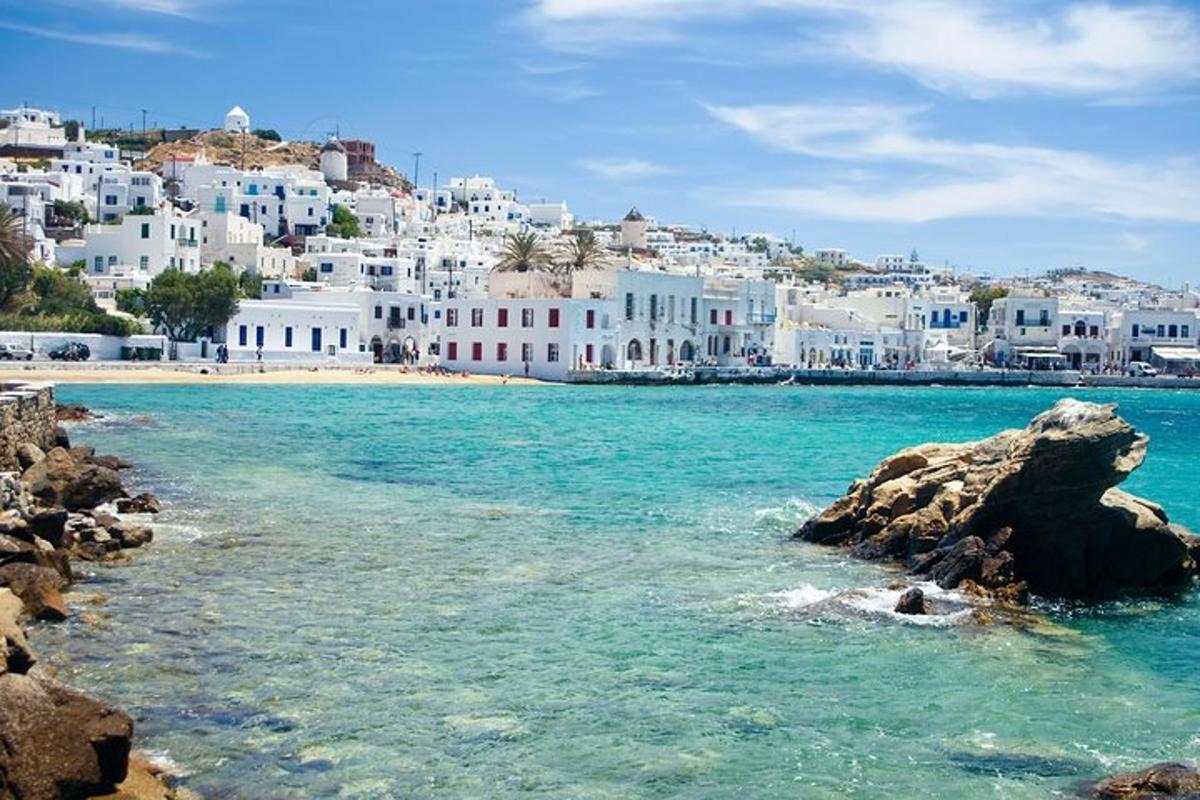 pogled na plažo z modro vodo in belimi stavbami
