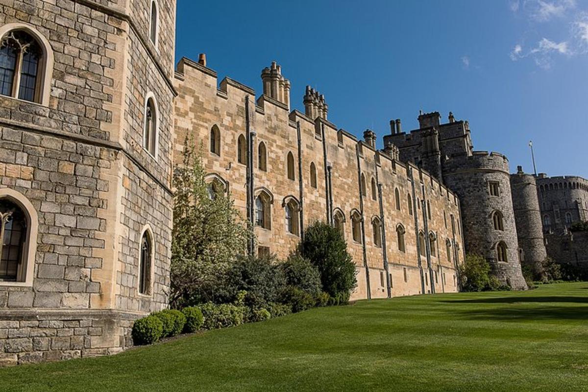 a large stone building with a green lawn in front of it