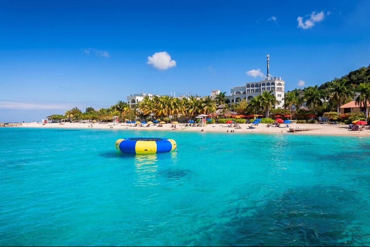 a blue and yellow tube in the water next to a beach