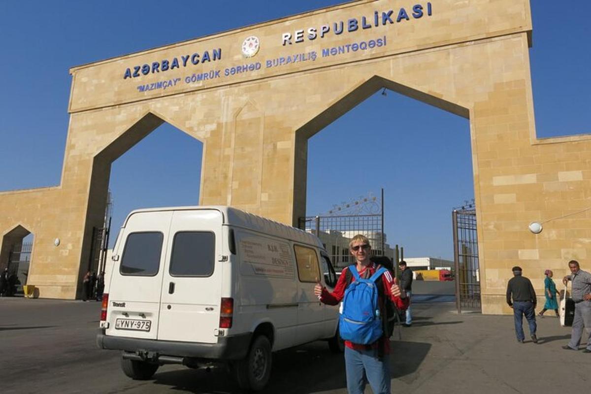a woman standing in front of a van in front of a building