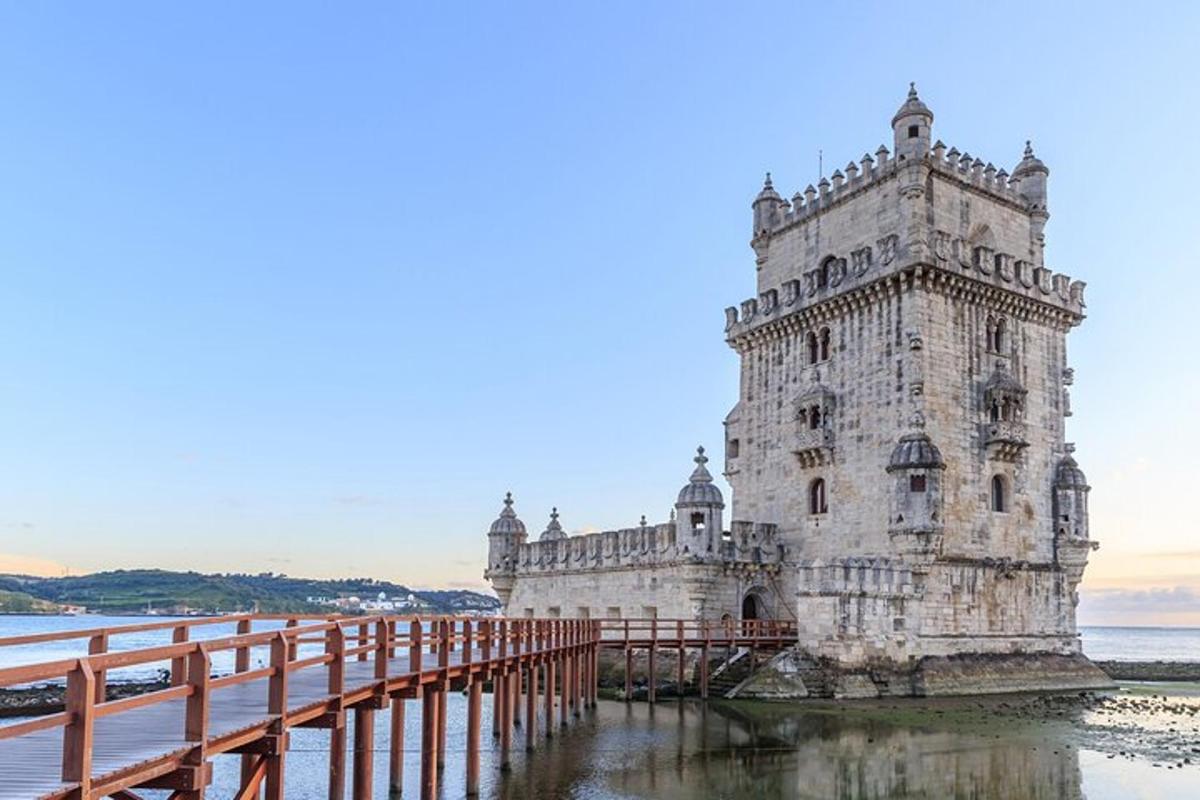 a lighthouse on the water next to a bridge