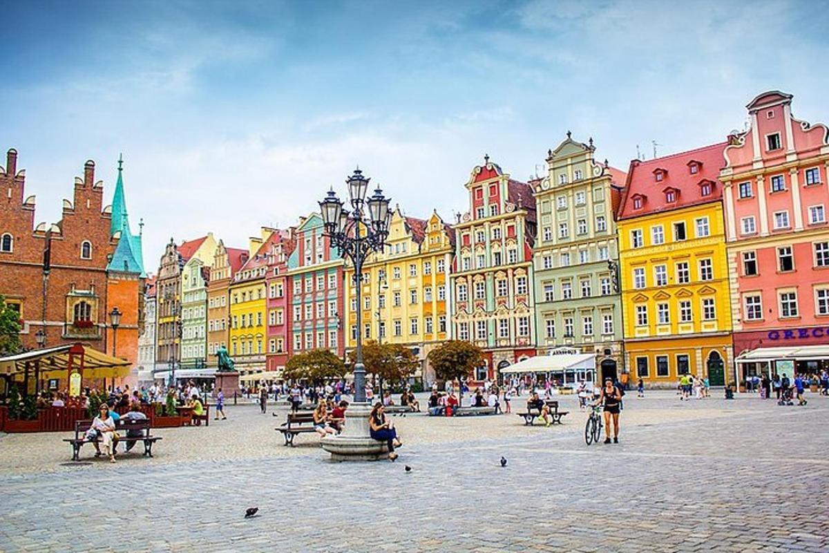 a group of buildings in a city with people sitting