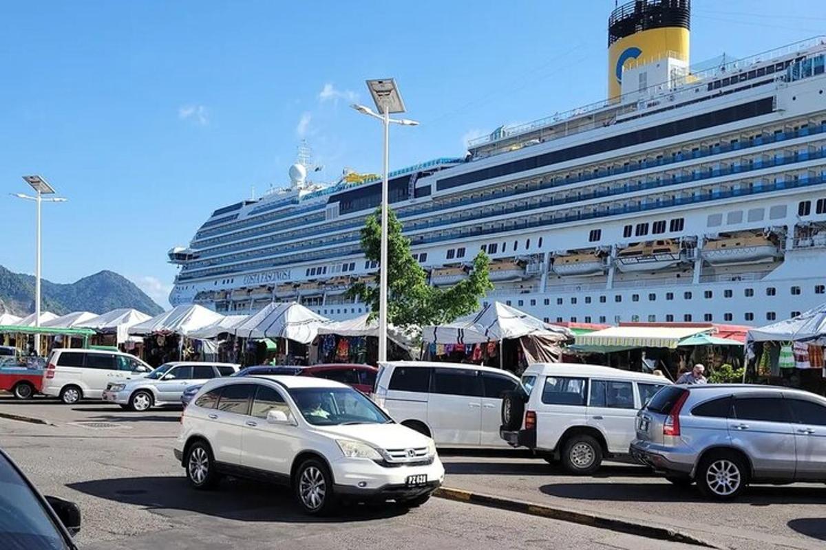 a cruise ship with cars parked in a parking lot