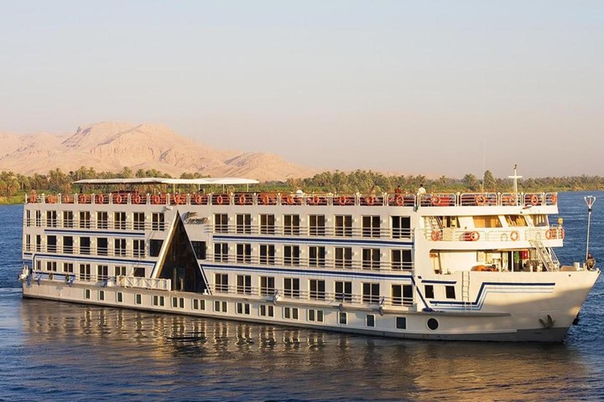 a large white cruise ship on the water
