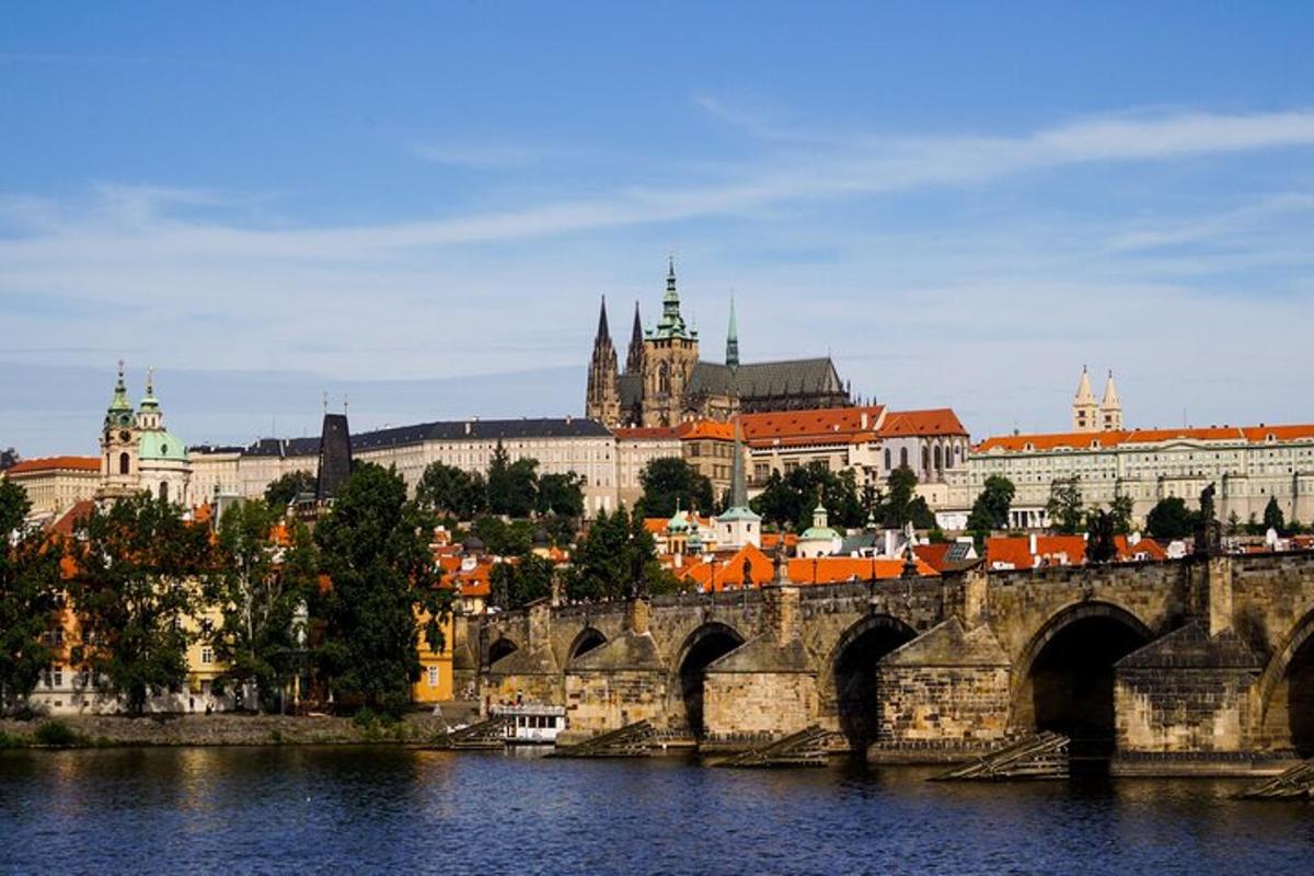 a bridge over a river with a city in the background