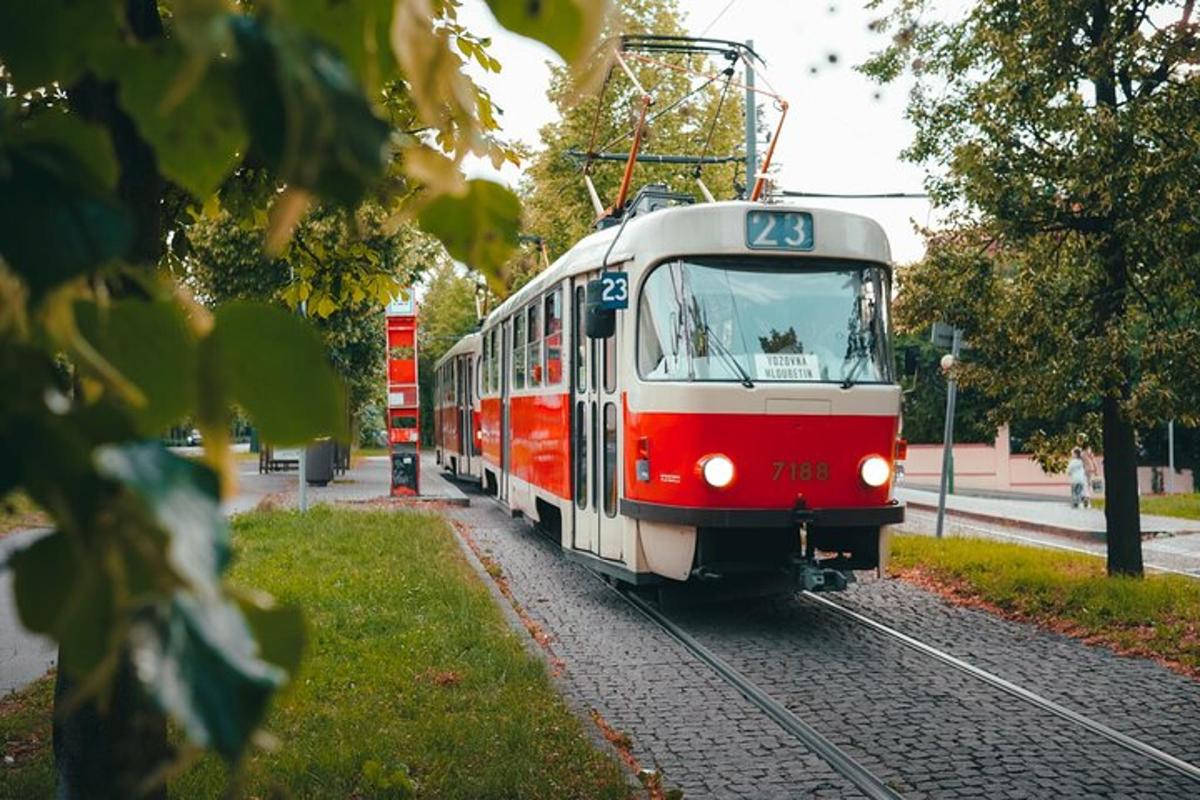 a red and white train traveling down the tracks