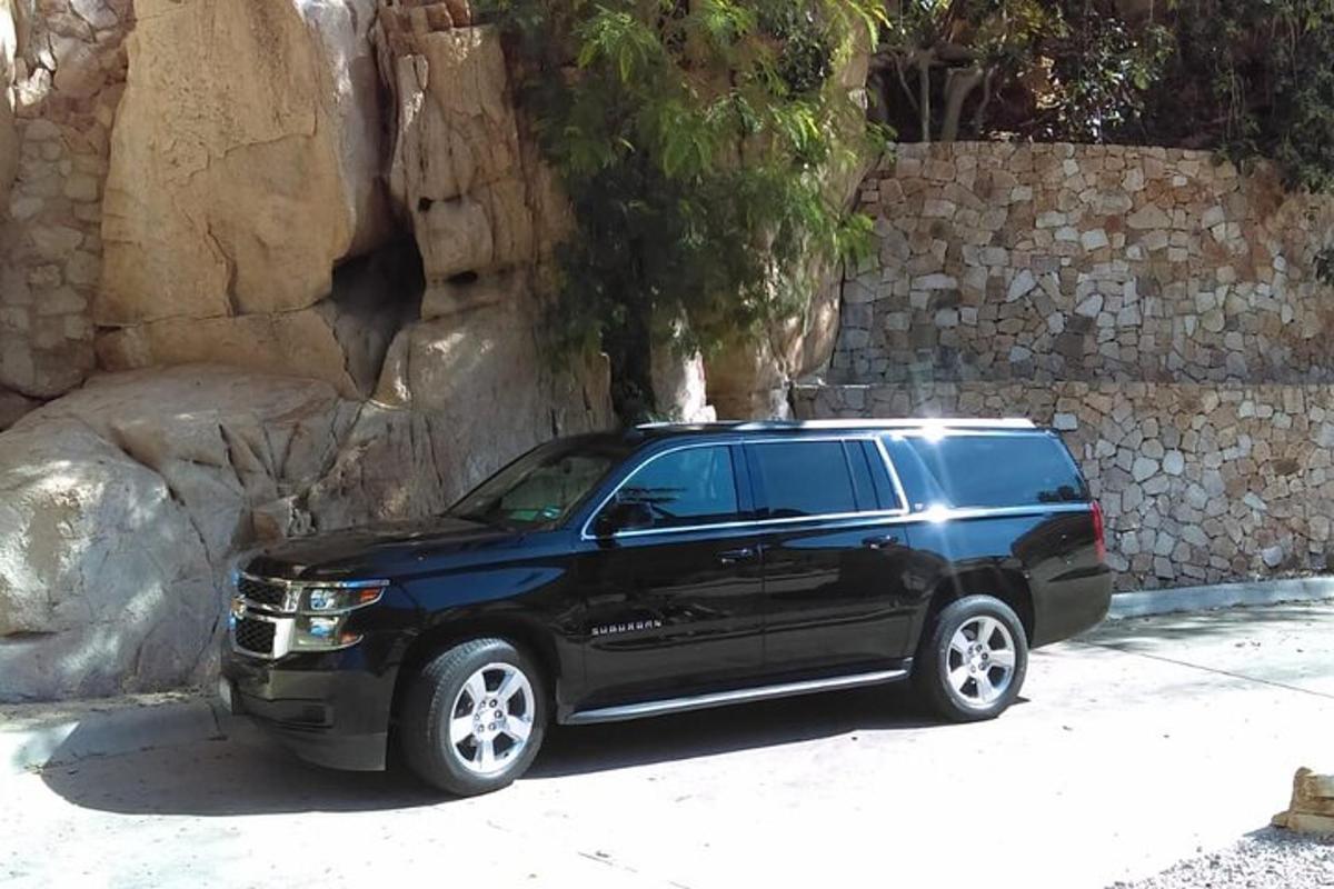 a black truck parked next to a stone wall