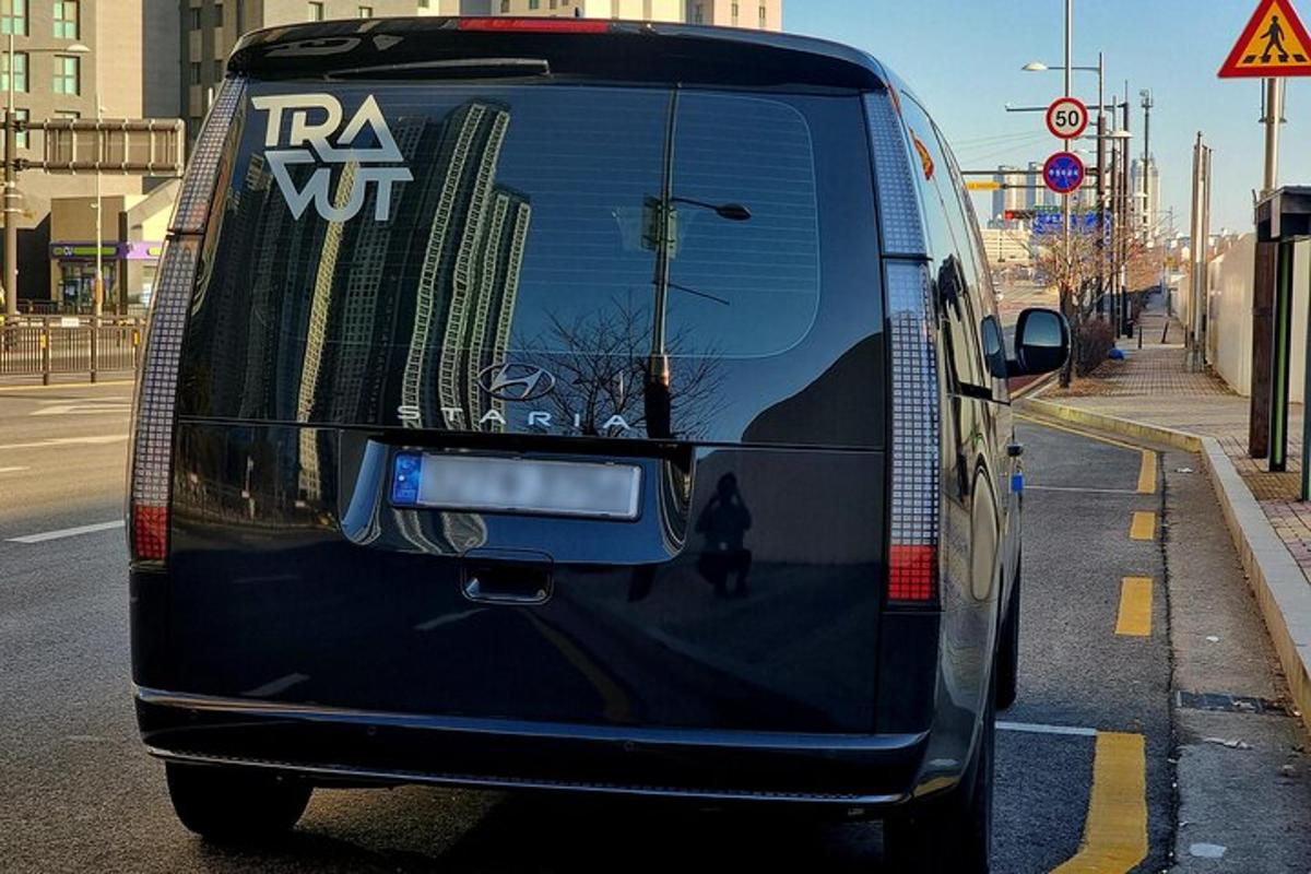 a black bus is parked on the street