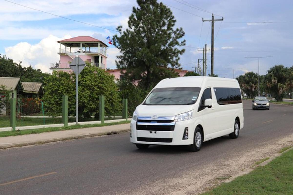 a white van is driving down a street