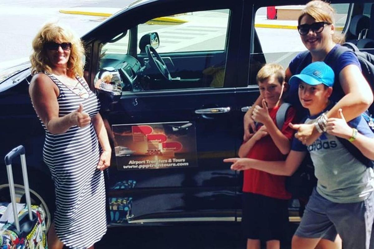 a group of people standing in front of a car
