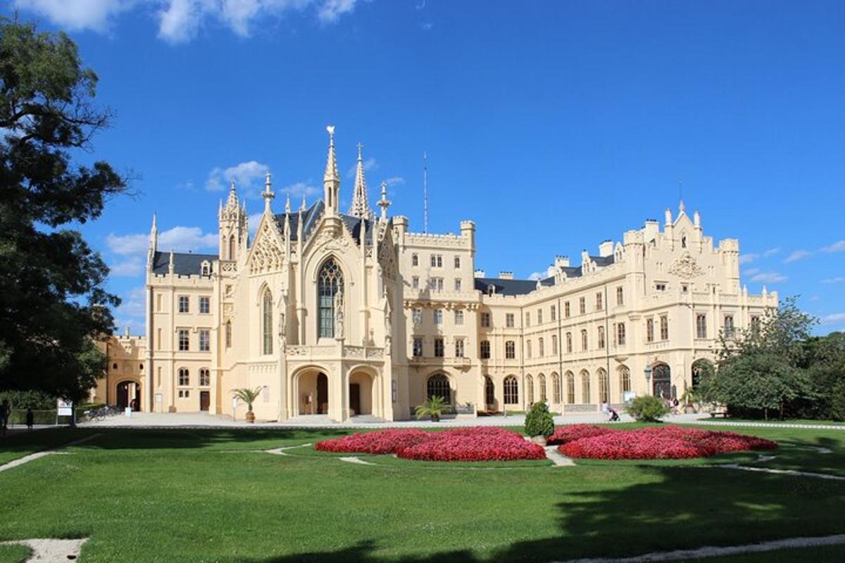 a large building with red flowers in front of it