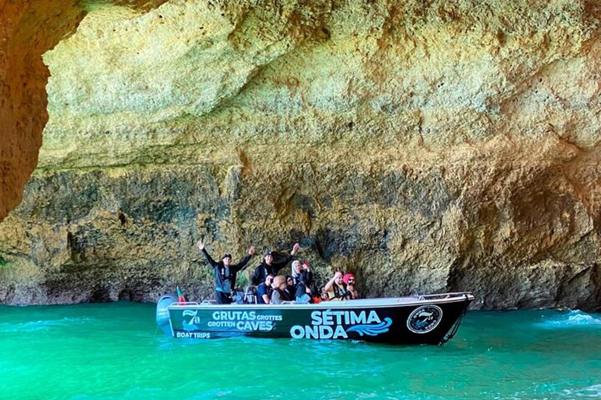 a group of people on a boat in front of a cliff
