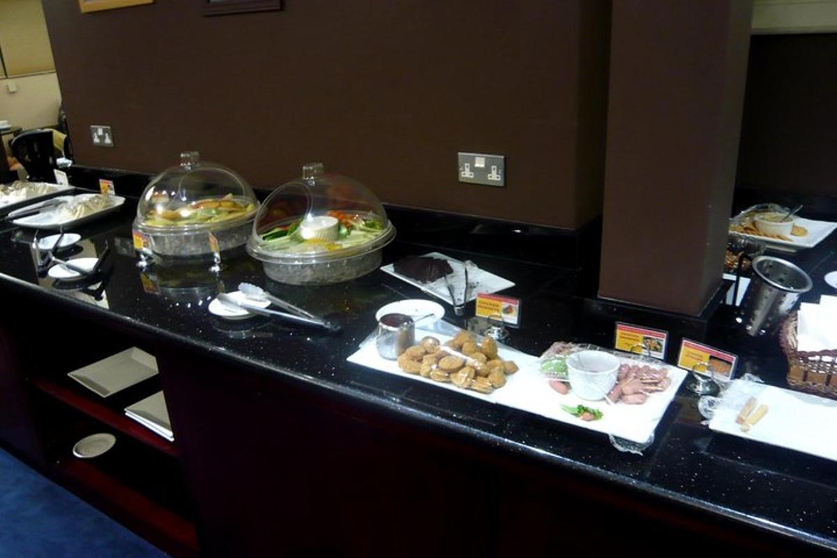 a buffet with food on a table in a hotel room