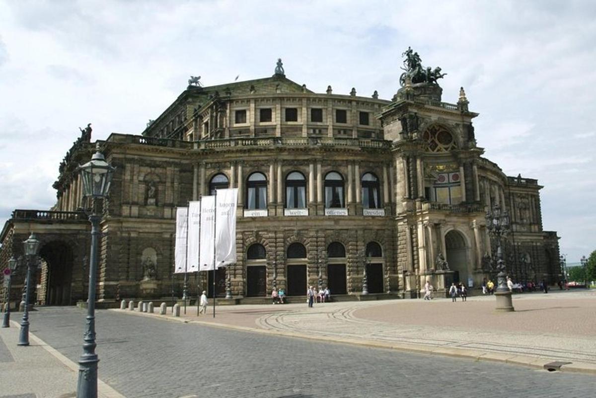 um grande edifício de pedra com pessoas caminhando na frente dele