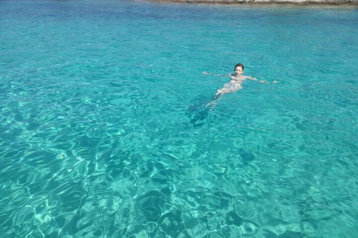 a person swimming in the blue water
