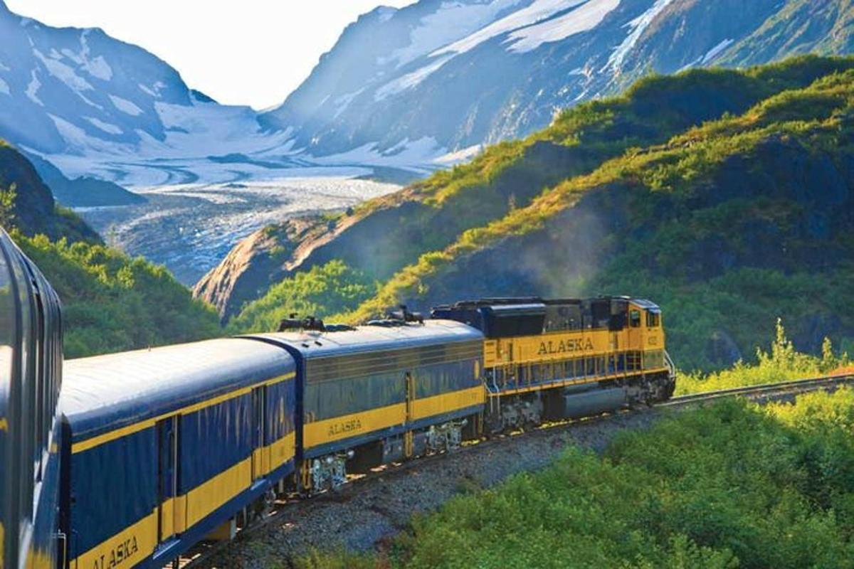 a train on the tracks with mountains in the background