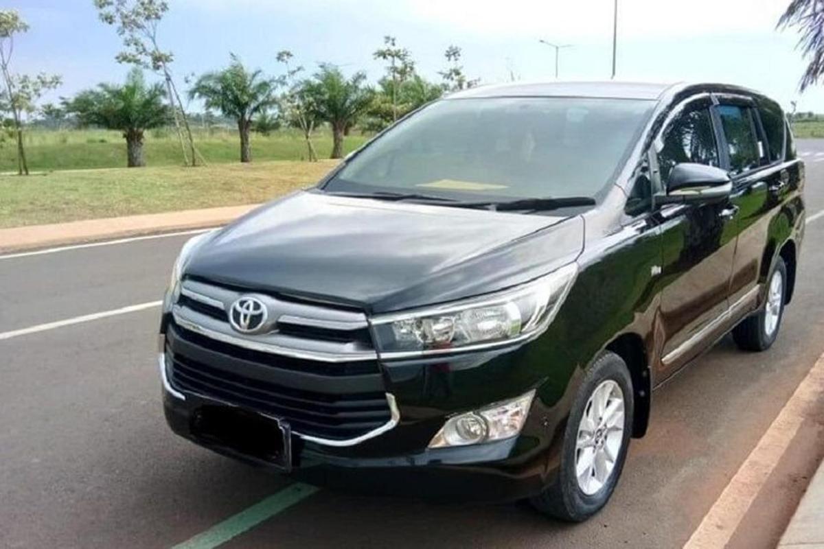 a toyota fortuner parked on the side of a road