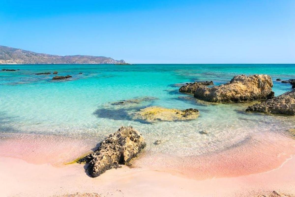 a beach with rocks in the water