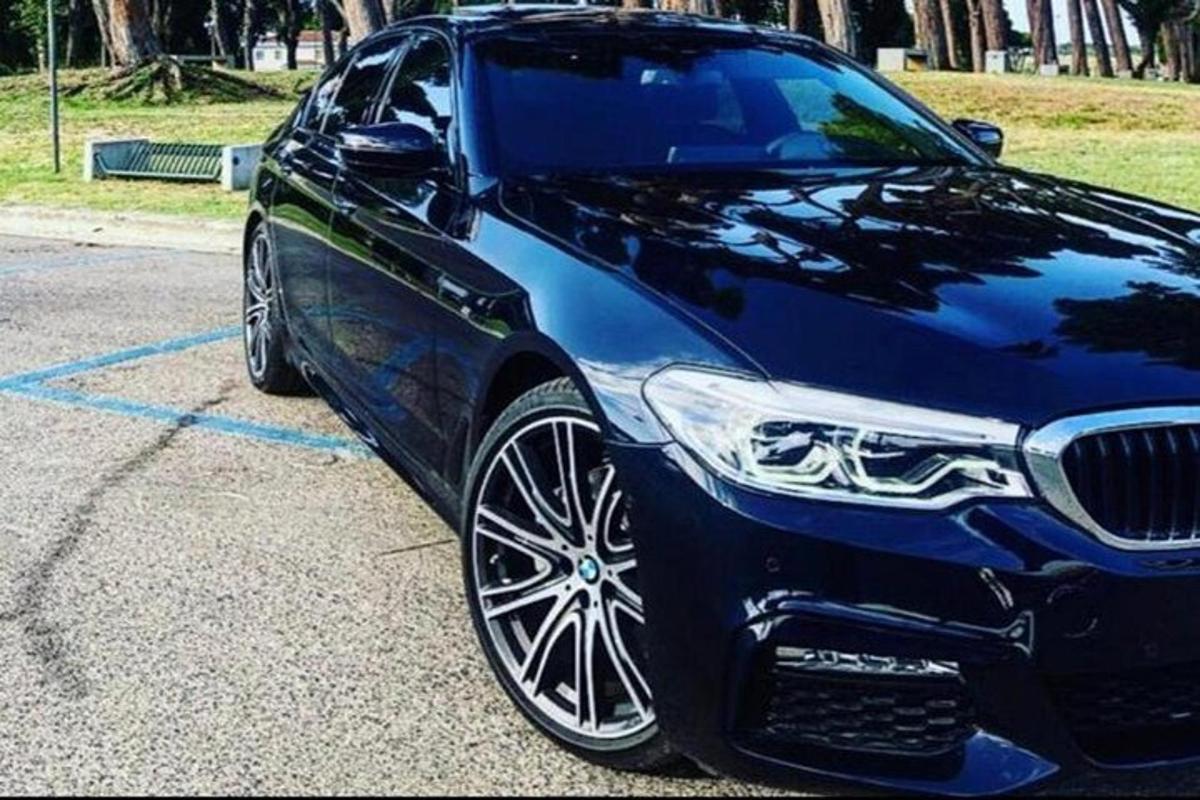 một chiếc xe màu xanh đỗ trong bãi đậu xe