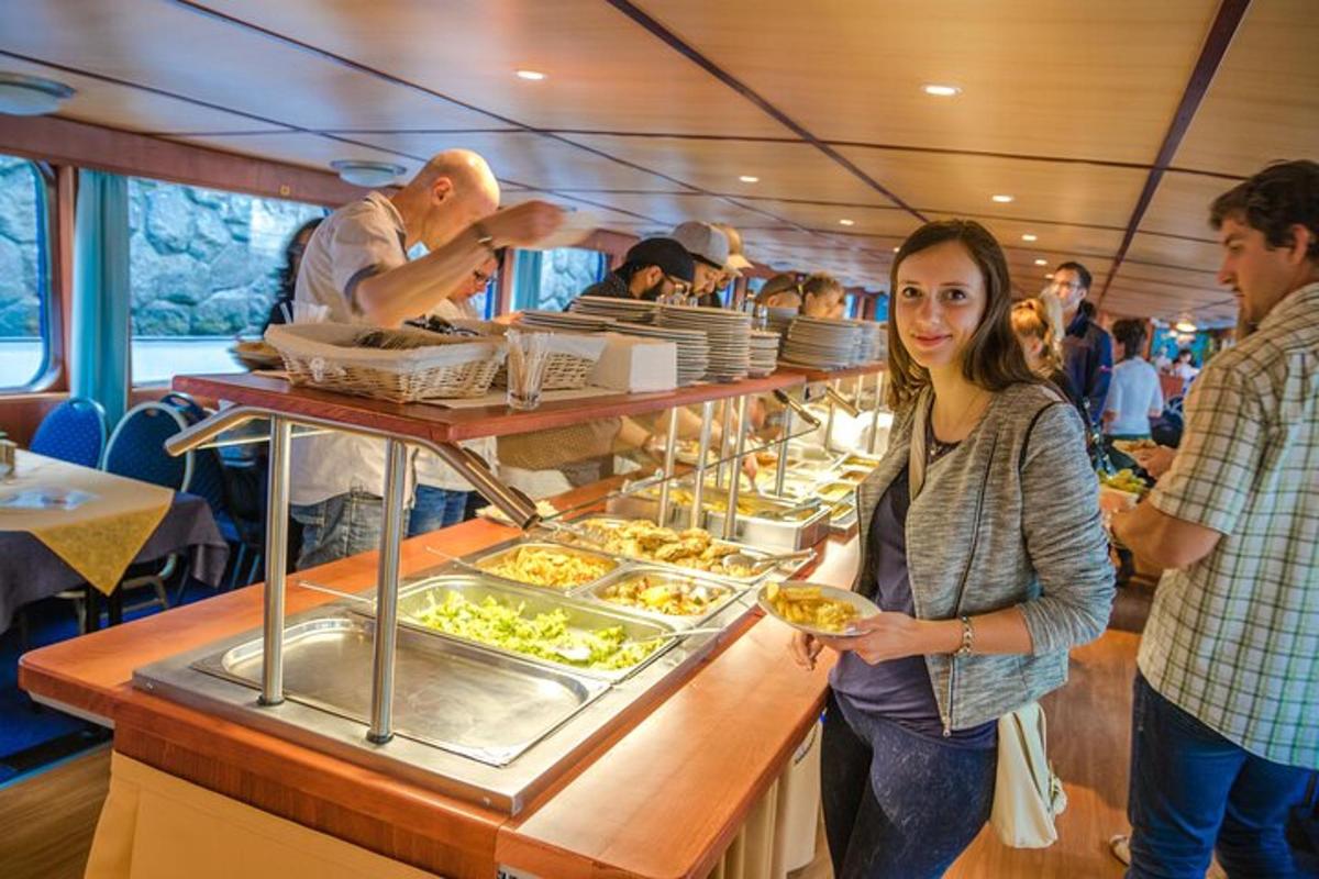 a woman standing in front of a buffet on a boat