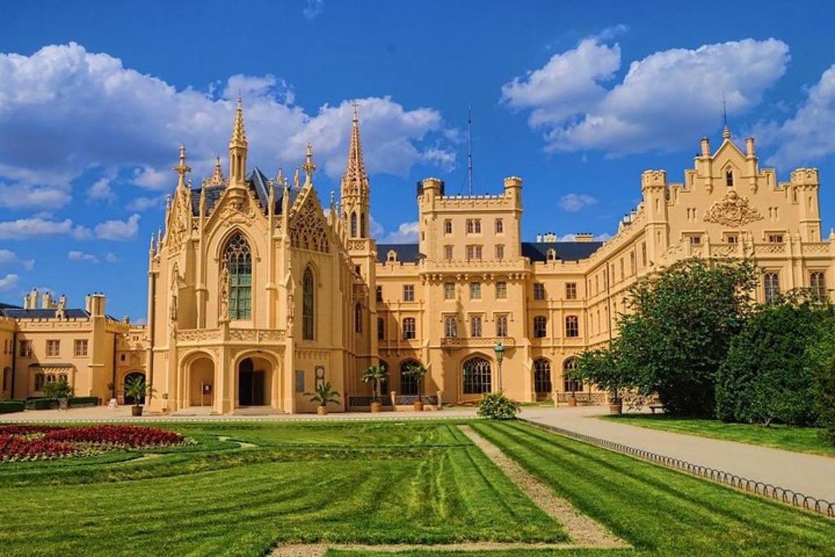 a large building with a green lawn in front of it