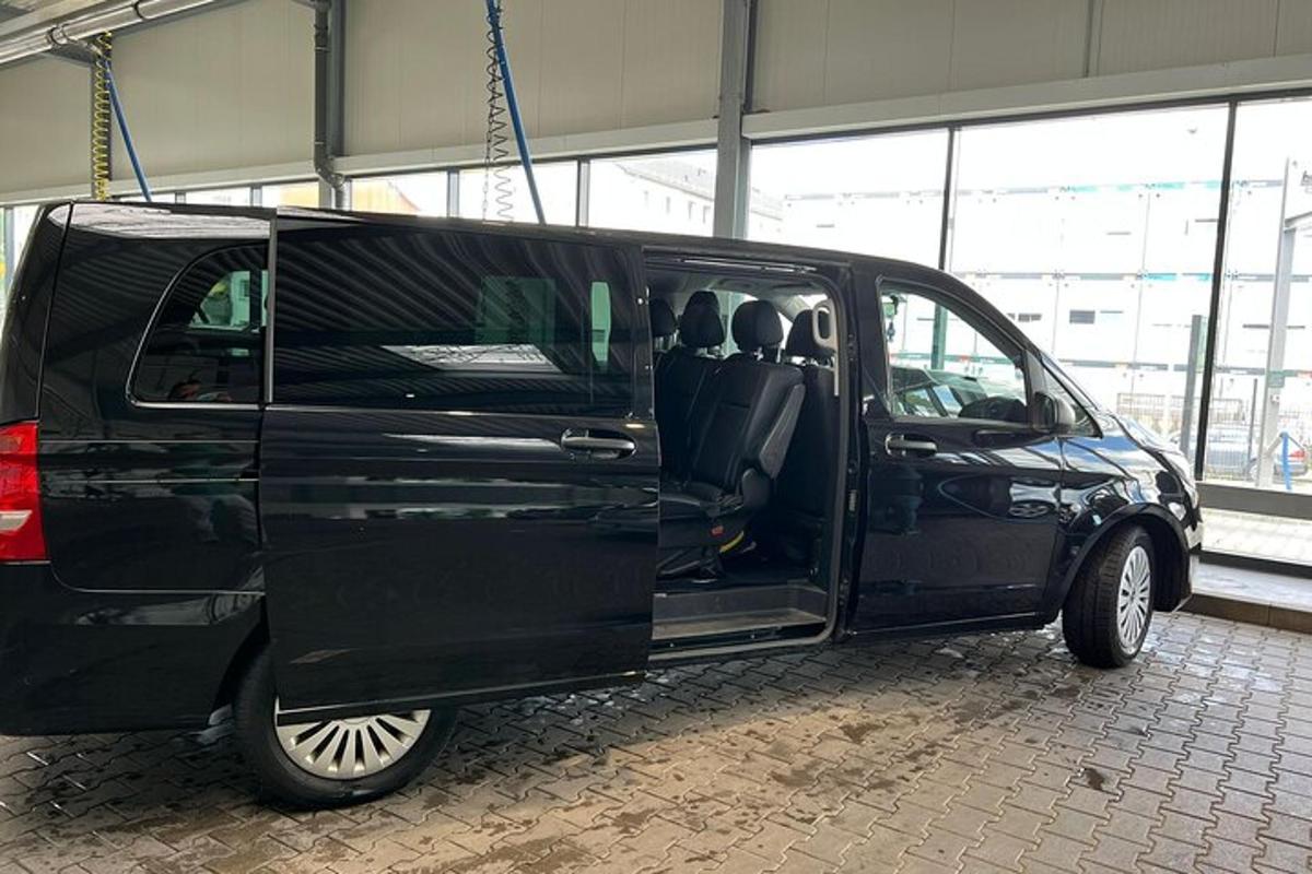 a black van with its doors open in a building