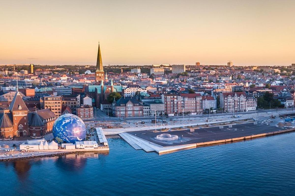 an aerial view of a city next to the water