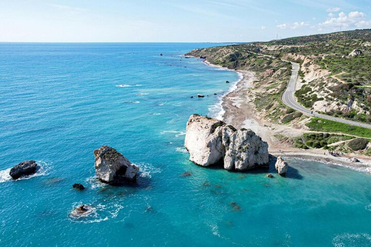 an aerial view of a beach with rocks in the water
